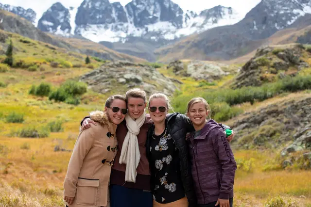 Diverse group of women of different ages smiling together outdoors